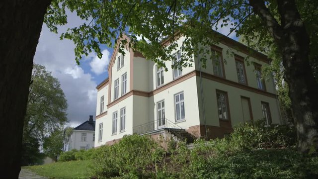 old house an trees in Tonsberg town Norway - camera dolly movement - direction right