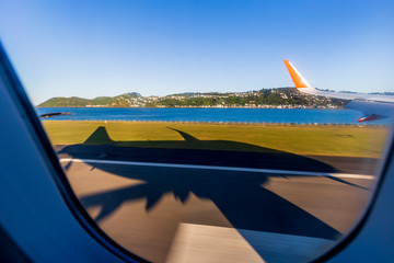 Wellington, New Zealand - August 24, 2019: Big shadow of an aeroplane arriving at Wellington airport, New Zealand.