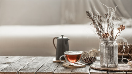 home decor beautiful vase with flowers and a Cup of tea.
