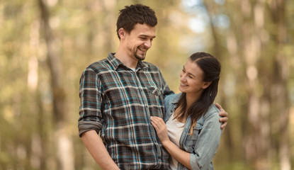 Obraz premium A young couple walking in the autumn forest.