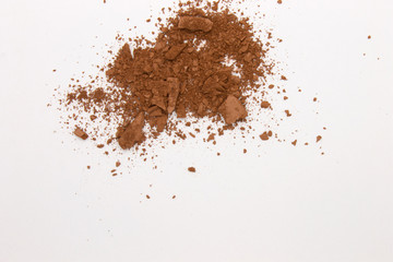 This is a photograph of a Matte Brown Powder Eyeshadow isolated on a White Background