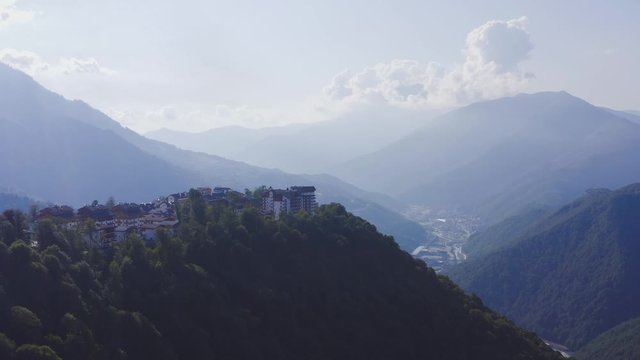 Aerial view rosa khutor resort in sochi. Sunny summer day. Mountain valley in a background