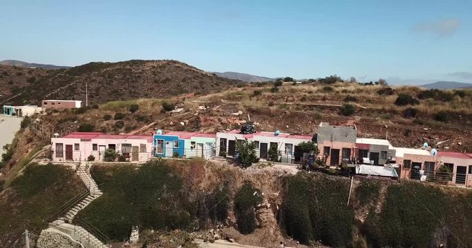 Drone footage of Haciendo Las Delicias, Baja, Mexico in the daytime. Starts with a wide angle then cinematically gets closer to the hillside homes