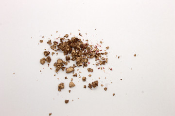 This is a photograph of a Metallic Gold Powder Eyeshadow isolated on a White Background