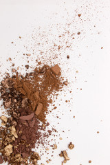 This is a photograph of a Matte Brown, Metallic Gold,and Deep Brown Powder Eyeshadow isolated on a White Background