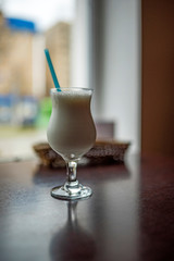Milkshake on a table in a cafe. Photographed close-up.