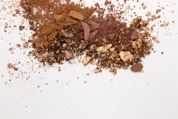 This is a photograph of a Matte Brown, Metallic Gold,and Deep Brown Powder Eyeshadow isolated on a White Background