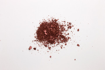 This is a photograph of a Burgundy Powder Eyeshadow isolated on a White Background