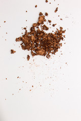 This is a photograph of a Metallic Bronze Powder Eyeshadow isolated on a White Background