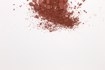 This is a photograph of a Burnt Umber Powder Eyeshadow isolated on a White Background