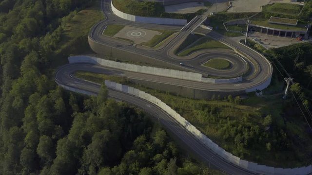 Aerial view empty mountain road in sunny day. Rosa khutor resort in Sochi, russia