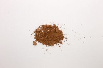 This is a photograph of a Brown Powder Eyeshadow isolated on a White Background