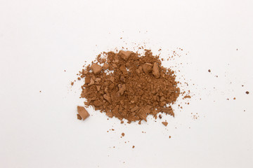 This is a photograph of a Brown Powder Eyeshadow isolated on a White Background