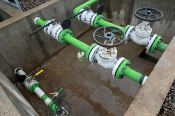 Industrial equipment (pipes, manometer/pressure gauge, levers, faucets, indicators) in a natural gas compressor station.