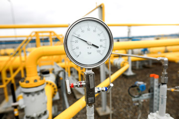 Industrial equipment (pipes, manometer/pressure gauge, levers, faucets, indicators) in a natural...