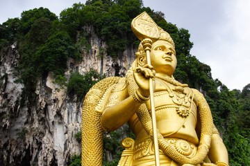 Detail of upper part of golden statue at Batu Caves religious site located in Selangor, outside of Kuala Lumpur in Malaysia.