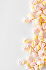 Candies. Marshmallows frame on white background top view copy space