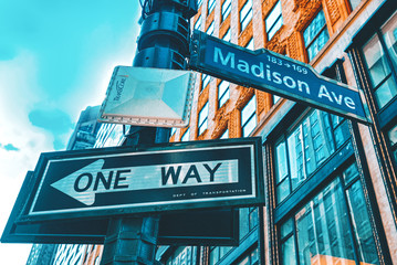 Street sign (nameplate) of Madison Avenue and urban cityscape of New York. USA.