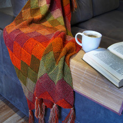 Knitted blanket, coffee and a book
