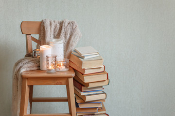 Still life home atmosphere in the interior with a book and candles, home decor elements, the...