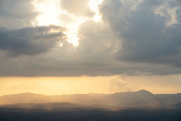 Beautiful strom rain clouds with sunrays at sunset