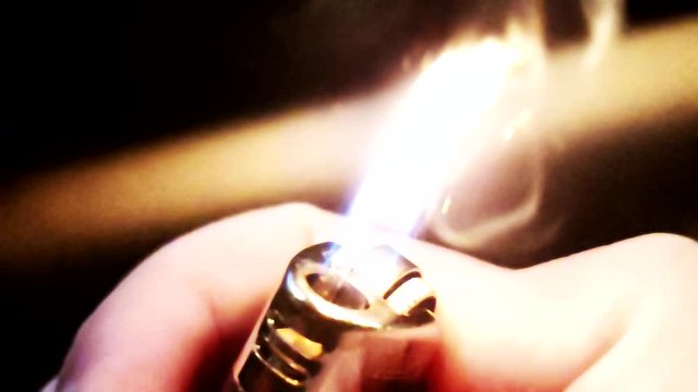 slow motion - Close up - Lighting a lighter