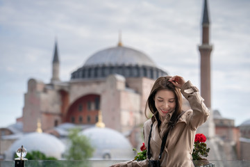 Woman portrait relaxing in Istanbul near Hagia Sophia famous islamic Landmark mosque.