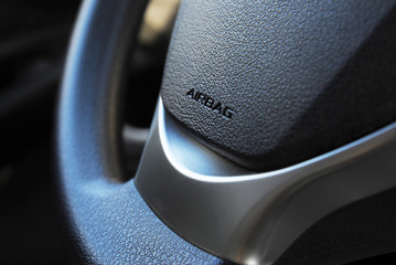 Airbag icon on steering wheel of car close up