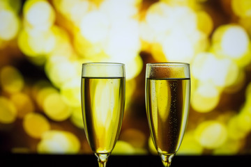 Two glasses of champagne on a bokeh background. Close-up isolated background.