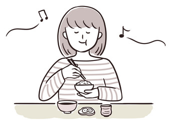 音楽を聞きながら食事をする女性