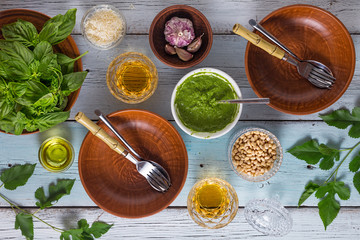 Italian cooking. Pasta with basil pesto and pine nuts. The ingredients are wine, parmesan and...