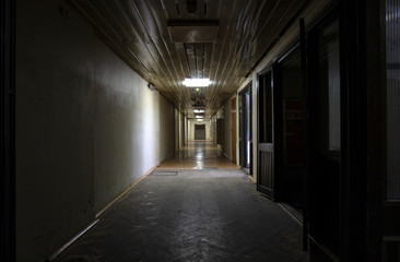 Long dark corridor in an old industrial building