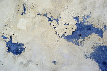 Old weathered painted wall background texture. Green dirty peeled plaster wall with falling off flakes of paint.Peeling paint on a metal surface.Cracked paint damaged concrete rough texture.