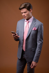 Studio shot of young handsome businessman in suit