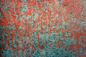 Old weathered painted wall background texture. Green dirty peeled plaster wall with falling off flakes of paint.Peeling paint on a metal surface.Cracked paint damaged concrete rough texture.