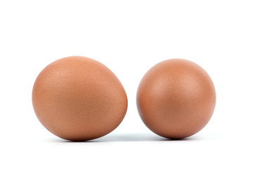 Two brown eggs separated with isolated from the white background.