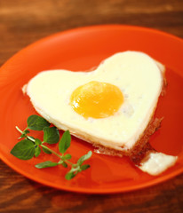 Fototapeta premium Fried Egg Sunny Side Up in Heart Shape