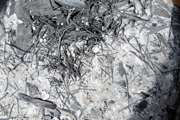 Black ash on the ground.
