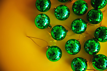 Green strobe Christmas balls on a yellow background