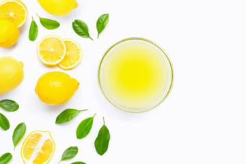 Fresh lemon with bowl of freshly squeezed lemon juice on white background.