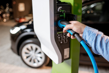 Plugging cable into the charging station