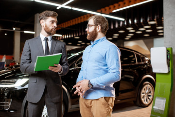 Sales consultant with a client at the car dealership