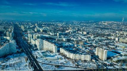 Obraz premium Top view of city in winter at sunset on sky background. Aerial drone photography concept. Kishinev, Republic of Moldova.