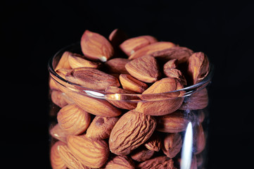 black background in glass almond,almond in glass and beautiful background,close up view of almond,almond view of close up