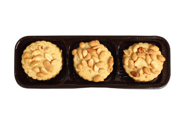 Peanut сookies in disposable plastic packing box. Isolated with clipping path. Directly Above.