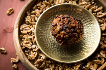 Walnuss Muffin in gold Messing Metall und Holz Schale mit Nüsse auf Holz Tisch Hintergrund