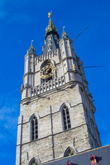 Fototapeta na wymiar Vertical picture of the medieval tower of the Belfry (Het Belfort) of Ghent taken from Sint-Baafsplein, in Belgium, Europe, during a sunny day. Tallest bell tower in Belgium with 91-meters high