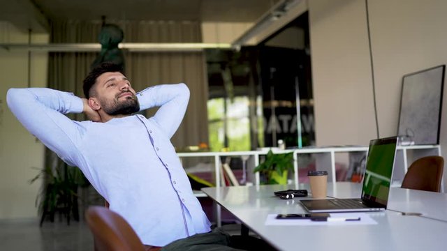Young man relaxed in office