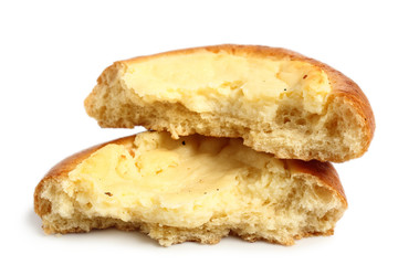 Vatrushka. Sweet yeast bread dough pastry with quark filling in the middle. Isolated on white background. Broken half and half. Macro.