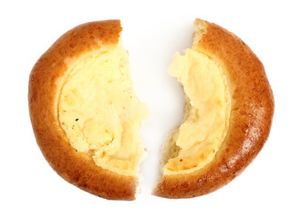 Vatrushka. Sweet yeast bread dough pastry with quark filling in the middle. Isolated on white background. Broken half and half. Directly Above.